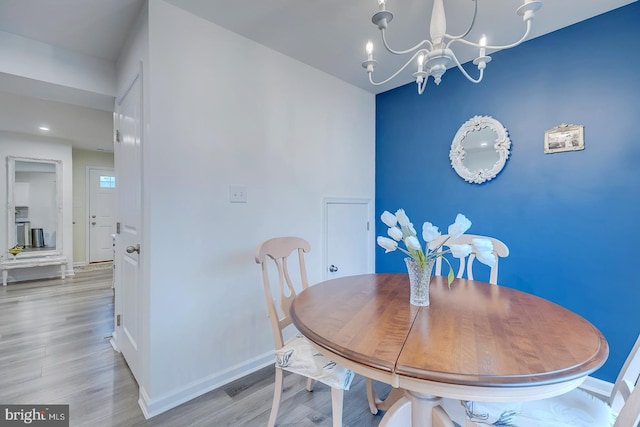 12086 Geyer Ave, Milford, DE 19963 - dining area with baseboards, wood finished floors, and an inviting chandelier