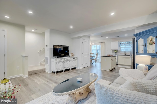 12086 Geyer Ave, Milford, DE 19963 - living room featuring stairs, light wood-style flooring, baseboards, visible vents, and recessed lighting