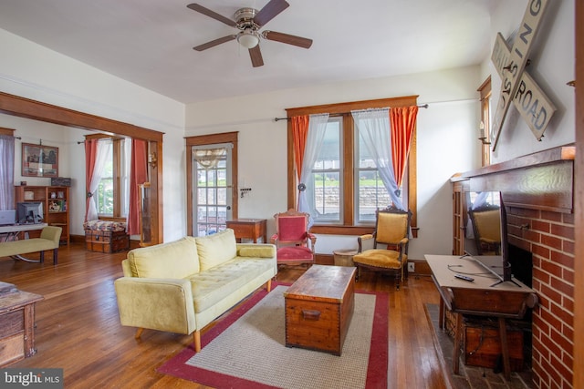 471 N Massanutten St, Strasburg, VA 22657 - living area featuring a brick fireplace, wood-type flooring, and a ceiling fan