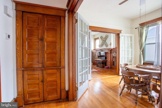 471 N Massanutten St, Strasburg, VA 22657 - dining space featuring wood finished floors, ceiling fan, and a brick fireplace