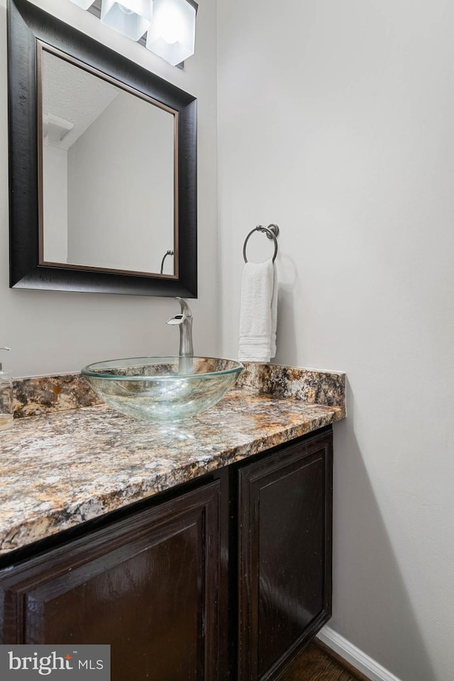 bathroom featuring baseboards and vanity