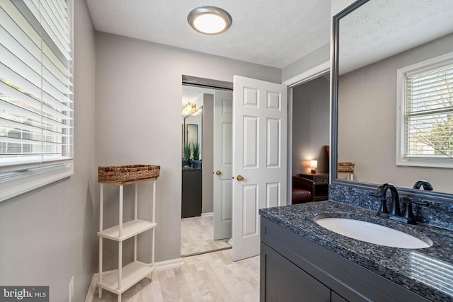 bathroom with vanity and a textured ceiling