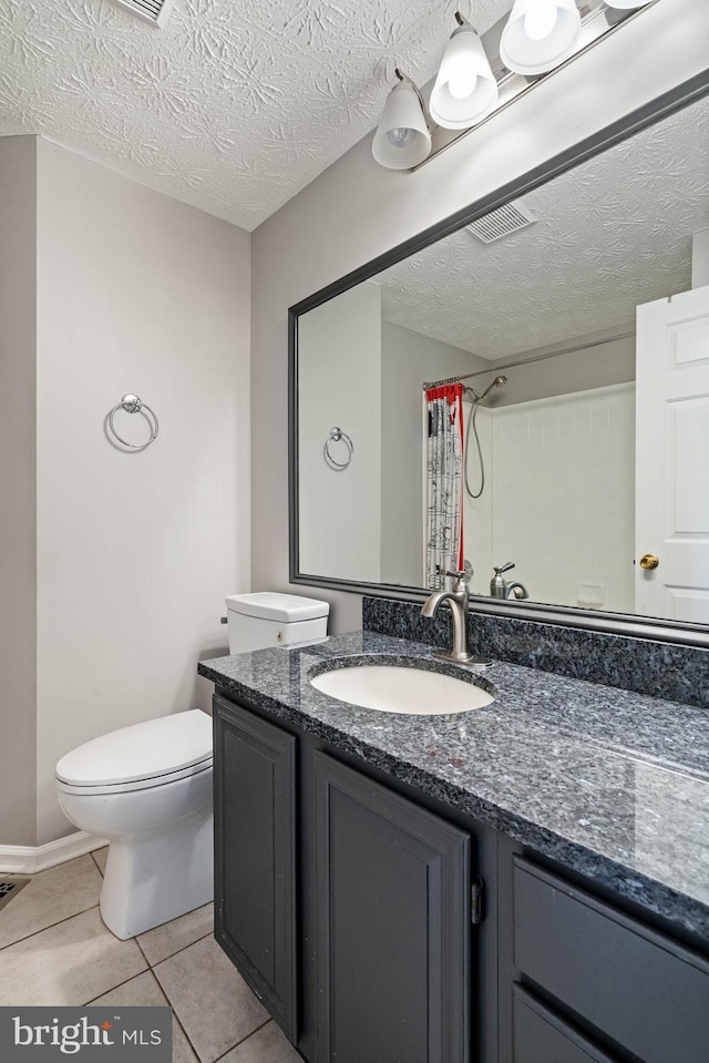 bathroom with curtained shower, vanity, a textured ceiling, and toilet