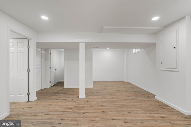 finished basement featuring recessed lighting, light wood-style floors, and baseboards