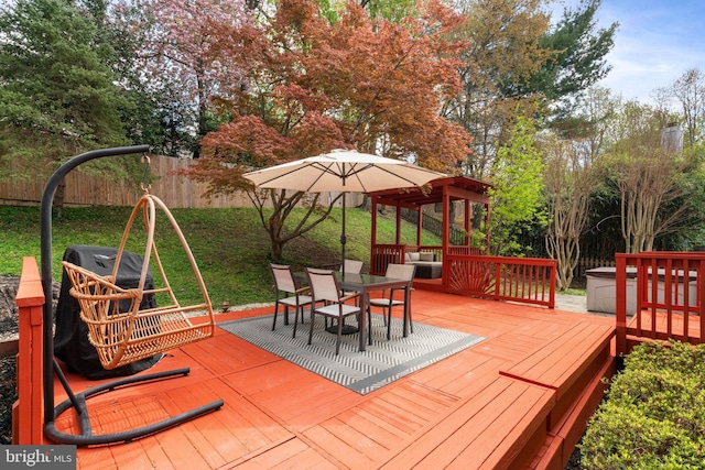 wooden terrace featuring outdoor dining area