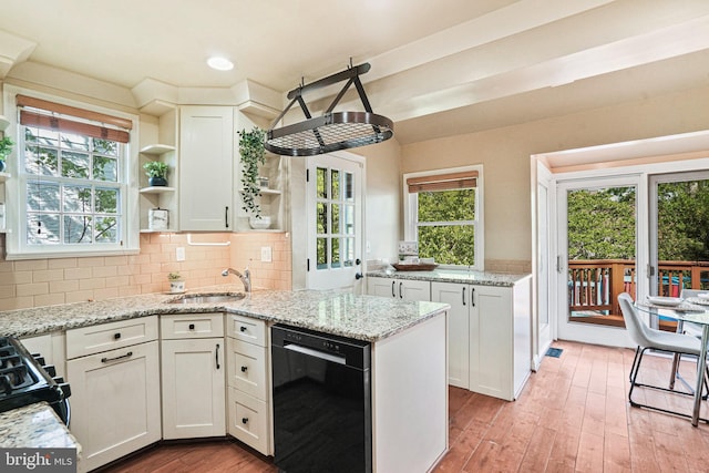 kitchen featuring plenty of natural light, open shelves, a sink, white cabinets, and black appliances