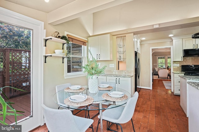 dining room featuring baseboards, ornamental molding, recessed lighting, and wood finished floors
