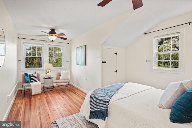 bedroom featuring wood-type flooring, baseboards, and ceiling fan