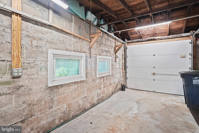 garage with concrete block wall