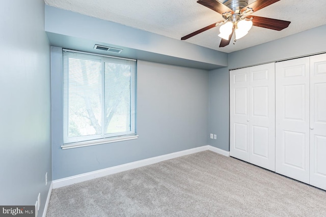 unfurnished bedroom featuring a closet, carpet flooring, baseboards, and visible vents