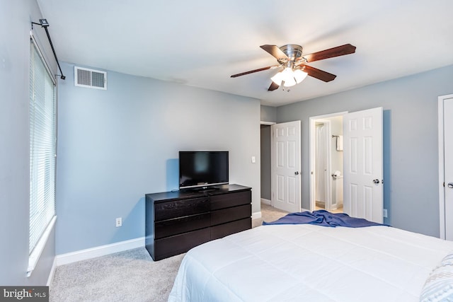 bedroom with light carpet, visible vents, baseboards, and ceiling fan