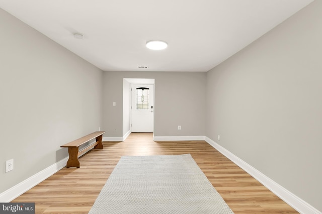 interior space with visible vents, light wood-type flooring, and baseboards