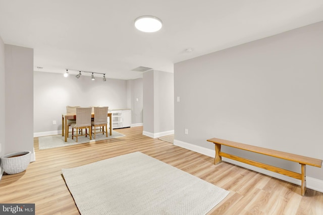 interior space featuring light wood-type flooring and baseboards