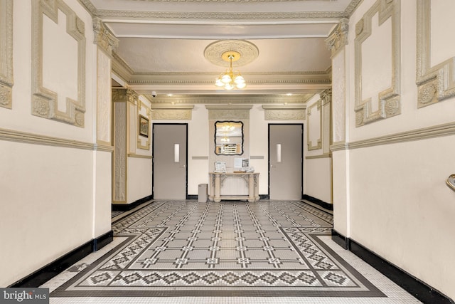 corridor with baseboards, crown molding, and an inviting chandelier