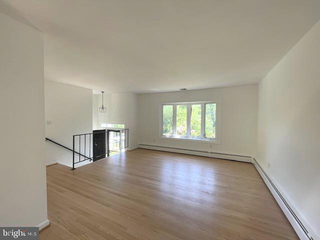 3433 Gregg Rd, Brookeville, MD 20833 - spare room featuring baseboard heating, wood finished floors, a baseboard radiator, and baseboards