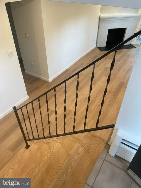 3433 Gregg Rd, Brookeville, MD 20833 - stairway featuring baseboards, a fireplace, and wood finished floors