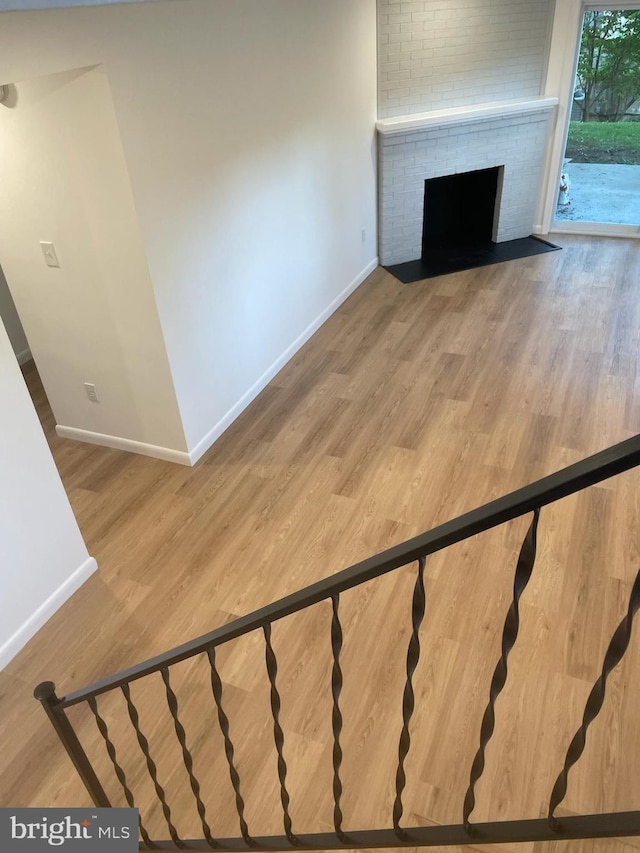 3433 Gregg Rd, Brookeville, MD 20833 - unfurnished living room with baseboards, a brick fireplace, and wood finished floors