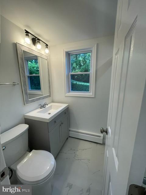 3433 Gregg Rd, Brookeville, MD 20833 - bathroom featuring a baseboard heating unit, marble look tile flooring, toilet, and vanity