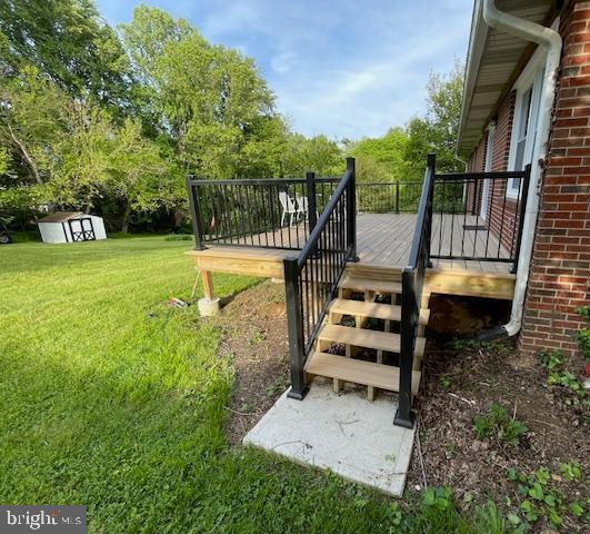 3433 Gregg Rd, Brookeville, MD 20833 - view of grassy yard featuring a wooden deck, a shed, an outbuilding, and stairs