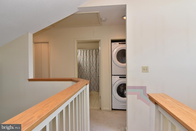 108 120th St Unit 5462, Ocean City, MD 21842 - laundry room featuring attic access, light carpet, stacked washer / dryer, and laundry area