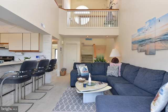 108 120th St Unit 5462, Ocean City, MD 21842 - living room featuring plenty of natural light, a towering ceiling, stairs, and visible vents