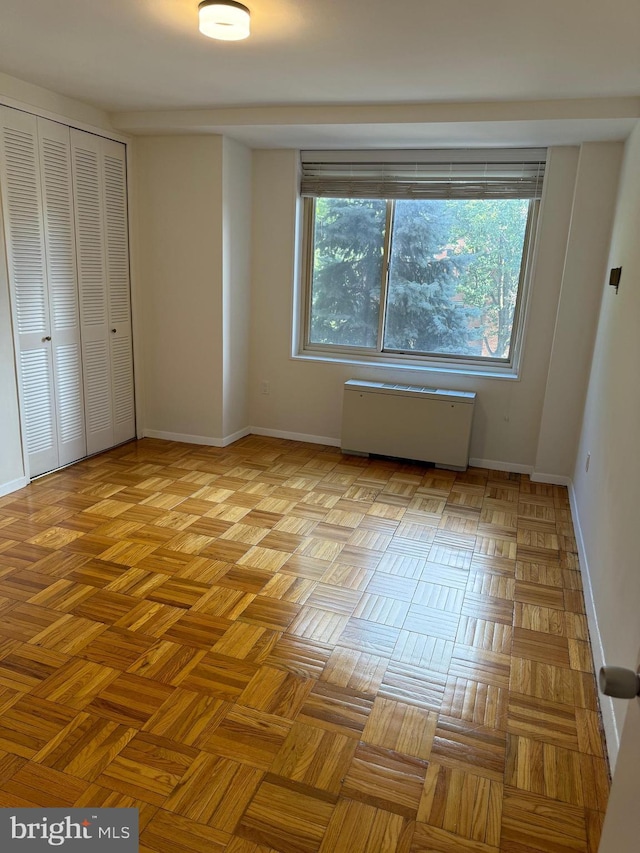 unfurnished bedroom featuring a closet and baseboards