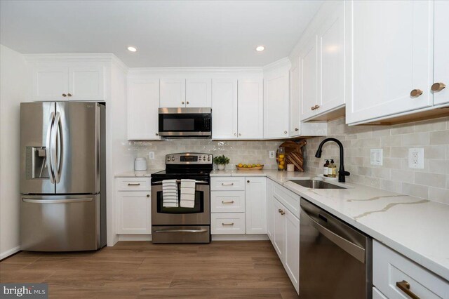 kitchen featuring white cabinets, a sink, and appliances with stainless steel finishes