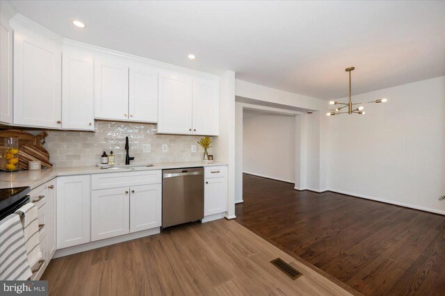 kitchen featuring light countertops, a sink, dishwasher, visible vents, and white cabinets