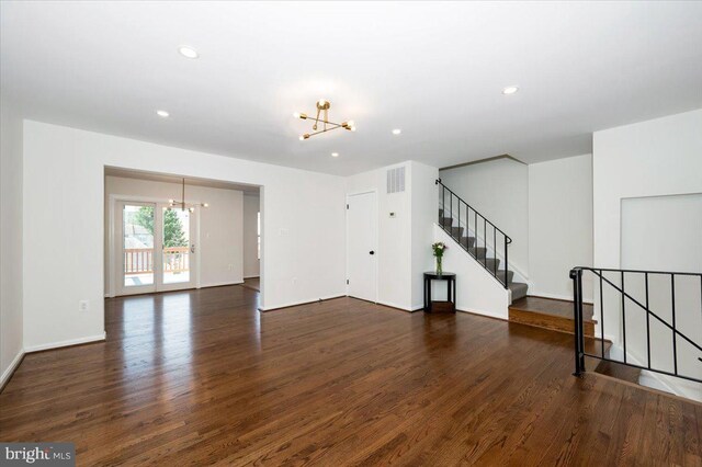 spare room featuring visible vents, wood finished floors, recessed lighting, and a chandelier