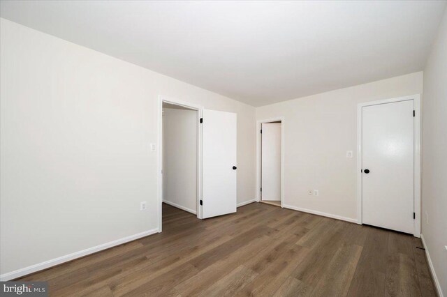 unfurnished bedroom featuring baseboards and wood finished floors
