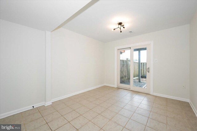 unfurnished room featuring light tile patterned floors, baseboards, and visible vents