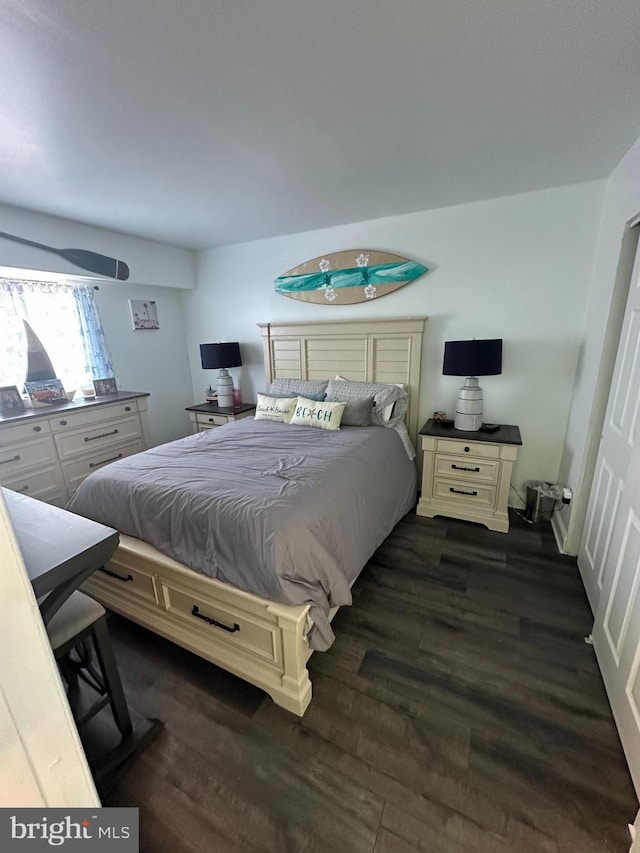 bedroom with dark wood finished floors