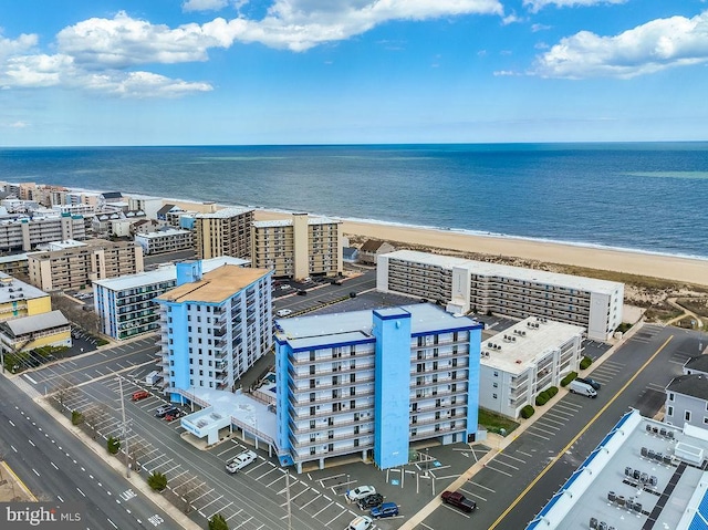 bird's eye view with a water view, a view of city, and a beach view
