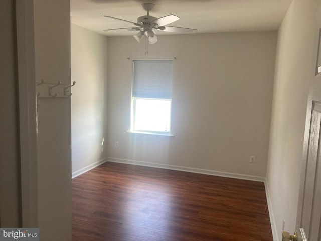empty room with baseboards, a ceiling fan, and wood finished floors