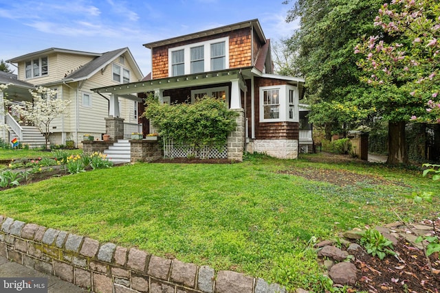 view of front of house with a front lawn and covered porch