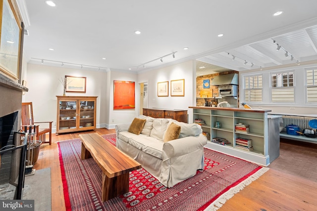 living room with rail lighting, a fireplace, wood-type flooring, and recessed lighting