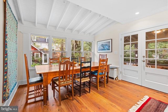 sunroom with french doors, radiator, and beam ceiling