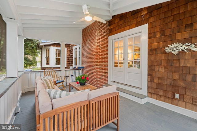 view of exterior entry featuring a porch, french doors, and a ceiling fan