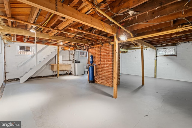 below grade area with washer / clothes dryer and stairs