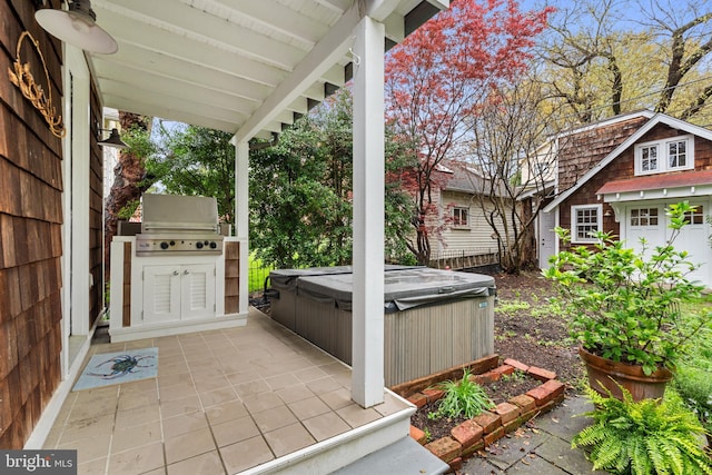 view of patio with grilling area and a hot tub