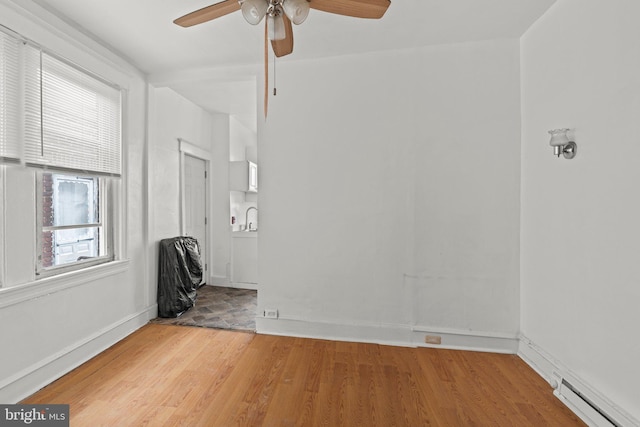 4935 Old York Rd, Philadelphia, PA 19141 - empty room featuring a ceiling fan, wood finished floors, baseboards, and baseboard heating