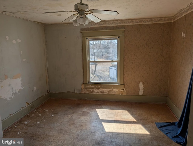 unfurnished room with baseboards and ceiling fan