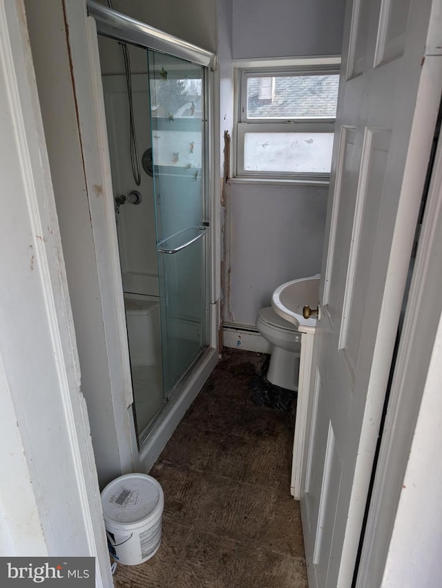 full bath featuring toilet and a shower stall