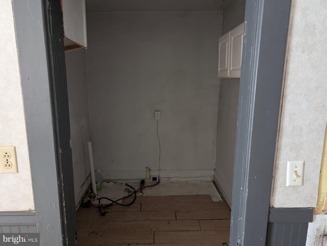 clothes washing area featuring hardwood / wood-style floors
