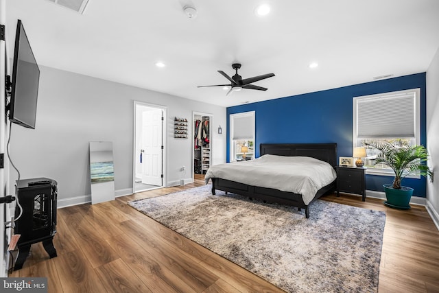 bedroom with wood finished floors, baseboards, visible vents, and recessed lighting