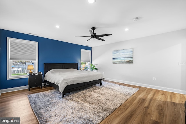 bedroom featuring recessed lighting, visible vents, baseboards, and wood finished floors