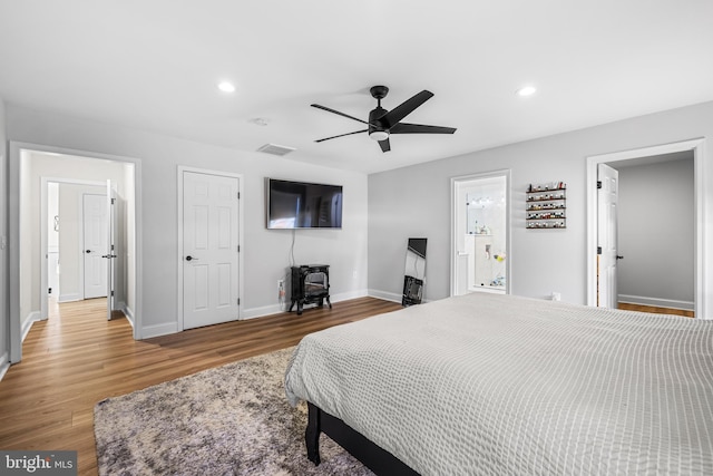bedroom with baseboards, recessed lighting, visible vents, ceiling fan, and wood finished floors