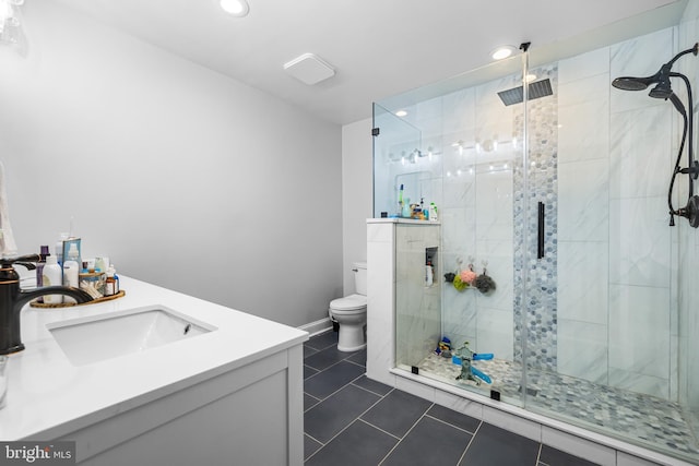 bathroom featuring tile patterned flooring, toilet, a stall shower, and vanity