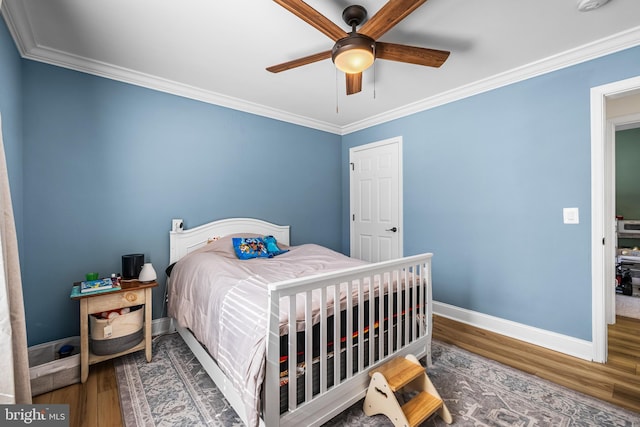 bedroom featuring ceiling fan, baseboards, ornamental molding, and wood finished floors