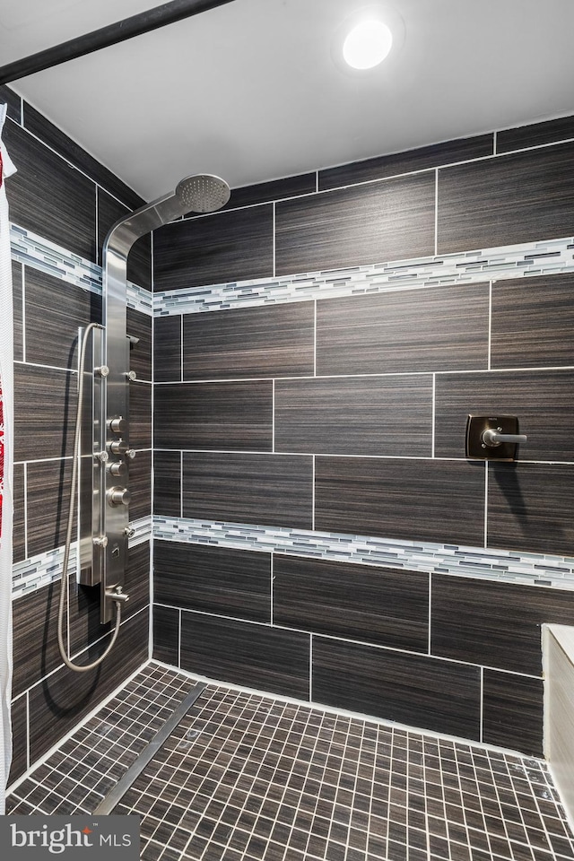 full bathroom with tiled shower